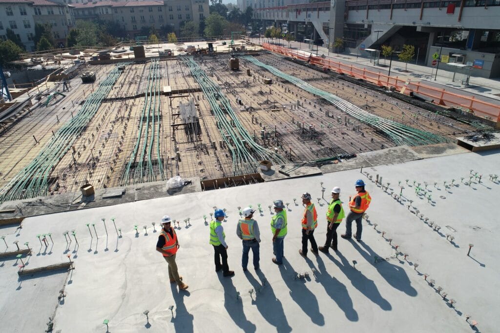 seven construction workers standing on white fieldمكتب استشارات هندسية: خدمات تصميم مخطط إنشائي متكاملة