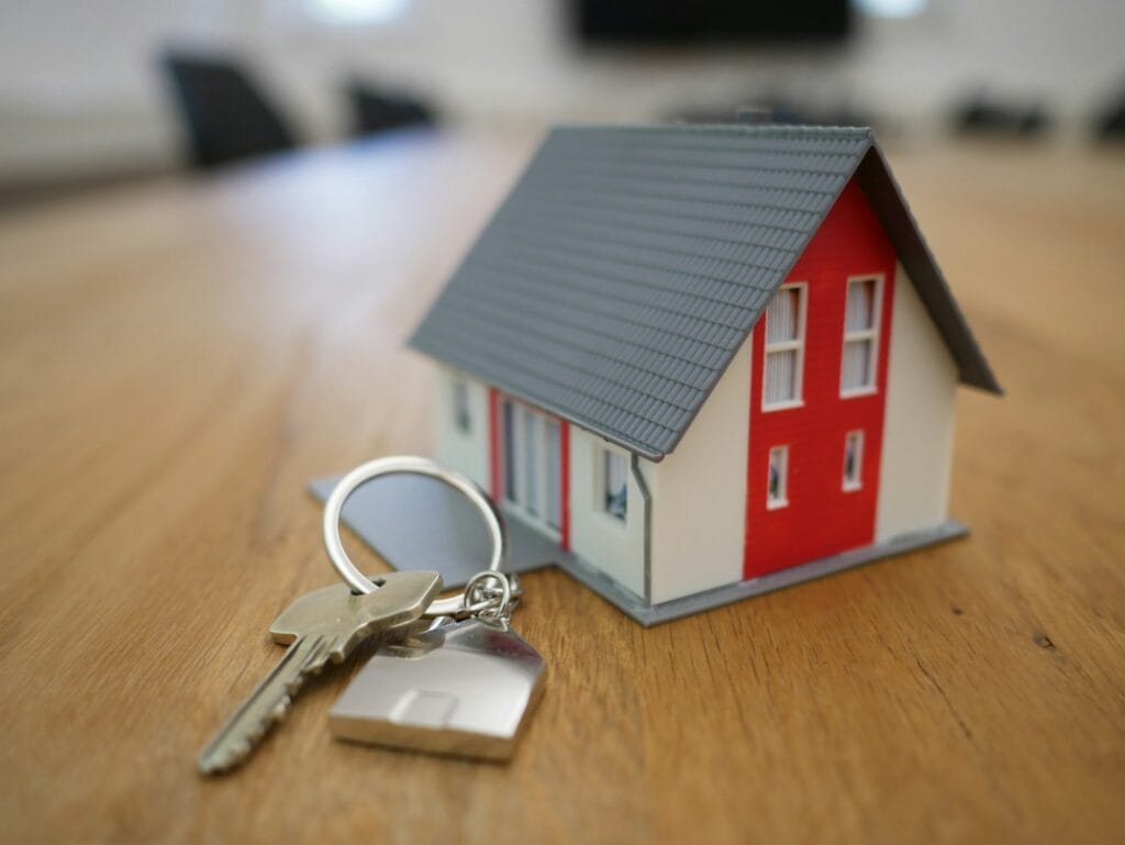 نقل ملكية عقار white and red wooden house miniature on brown table